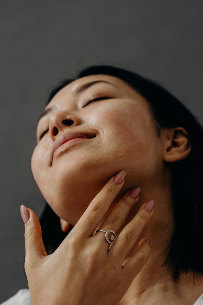 a woman doing a lymphatic facial massage