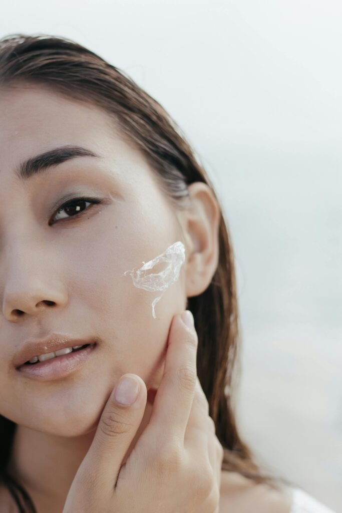 a woman applying a facial cleanser on face